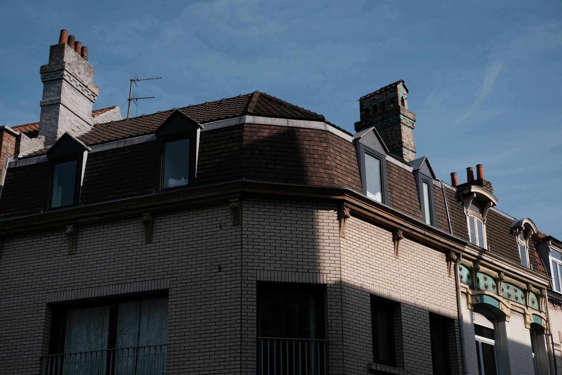 A low angle shot of a historic brick building facade under clear blue skies.